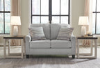 Gray loveseat with four striped throw pillows and two plush seat cushions