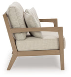 Beige loveseat with striped pillows and driftwood armrests, cushioned seat