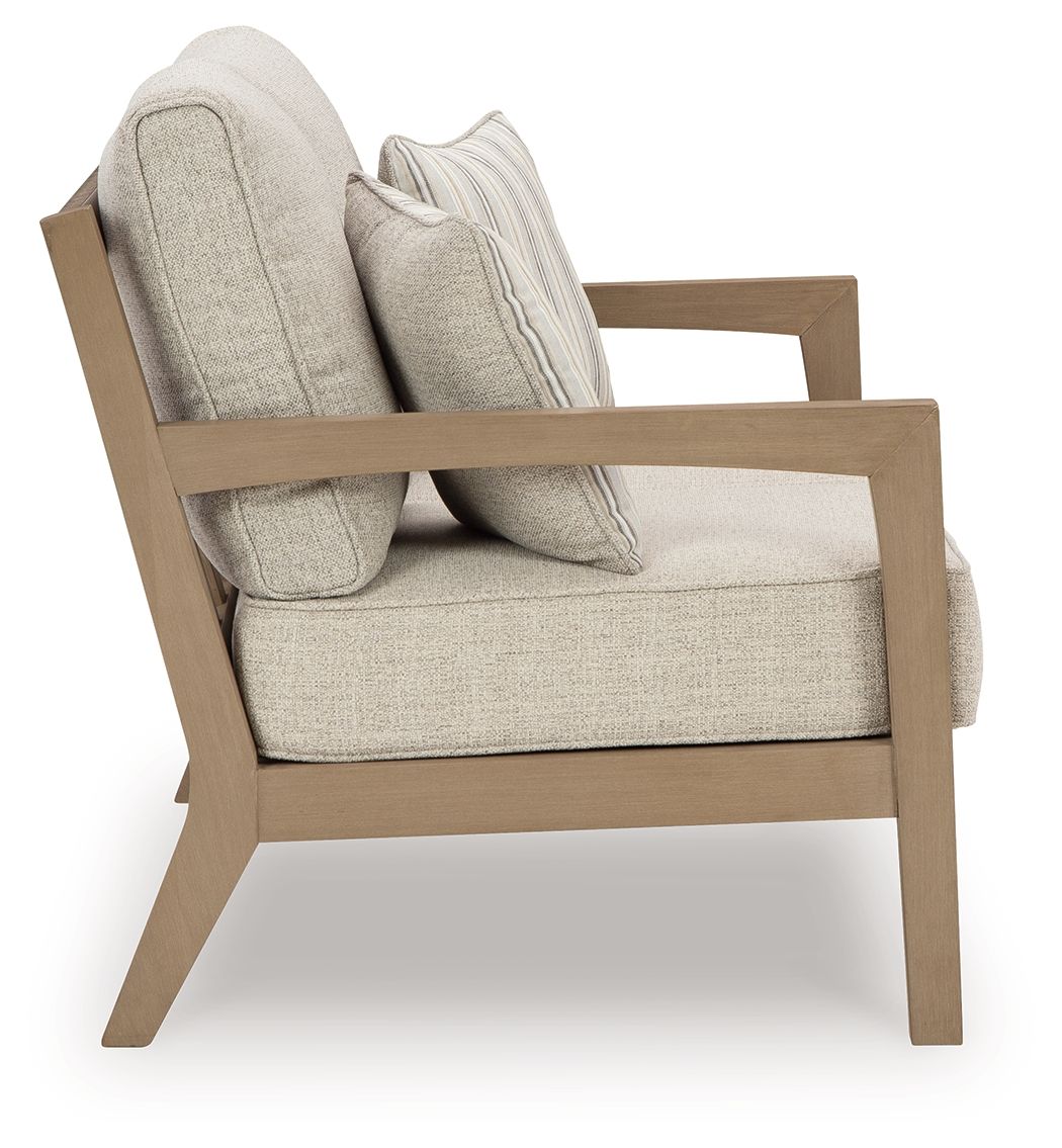 Beige loveseat with striped pillows and driftwood armrests, cushioned seat