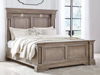 Light brown panel bed frame with detailed headboard and low footboard, side view