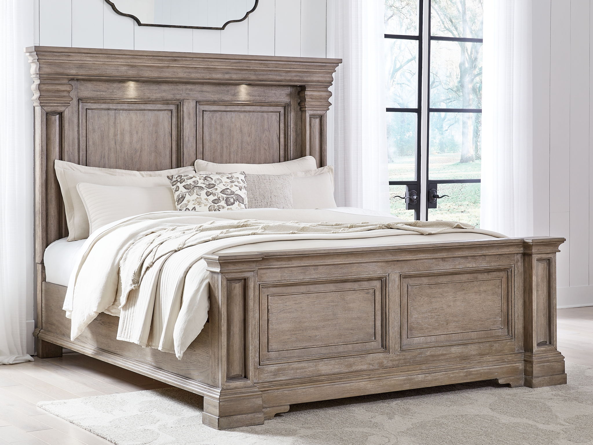 Light brown panel bed frame with detailed headboard and low footboard, side view