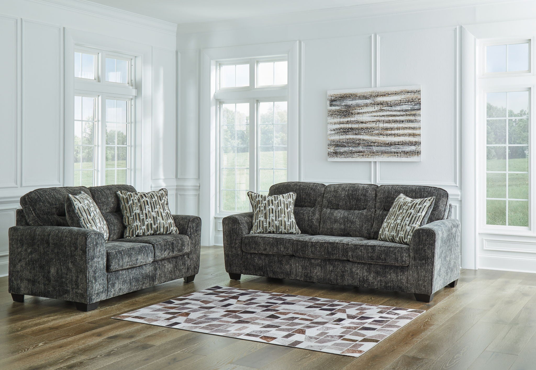 Dark gray fabric loveseat and sofa with patterned pillows and square arms