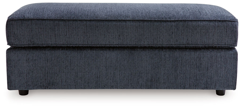 Oversized accent ottoman in cobalt blue upholstery with thick top cushion and legs