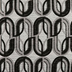 Patterned accent pillow fabric with repeating circular motif in black and gray