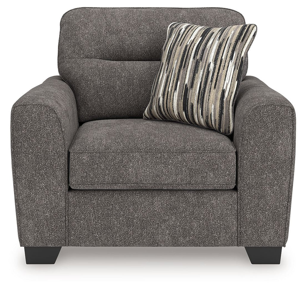 Dark gray upholstered chair and a half with seat cushion and striped throw pillow