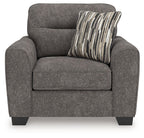 Dark gray upholstered chair and a half with seat cushion and striped throw pillow