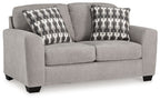 Gray flannel loveseat with two patterned throw pillows