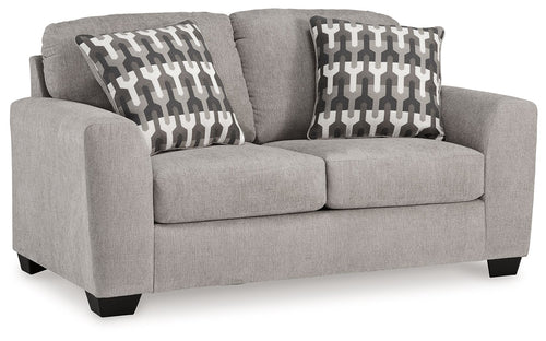 Gray flannel loveseat with two patterned throw pillows