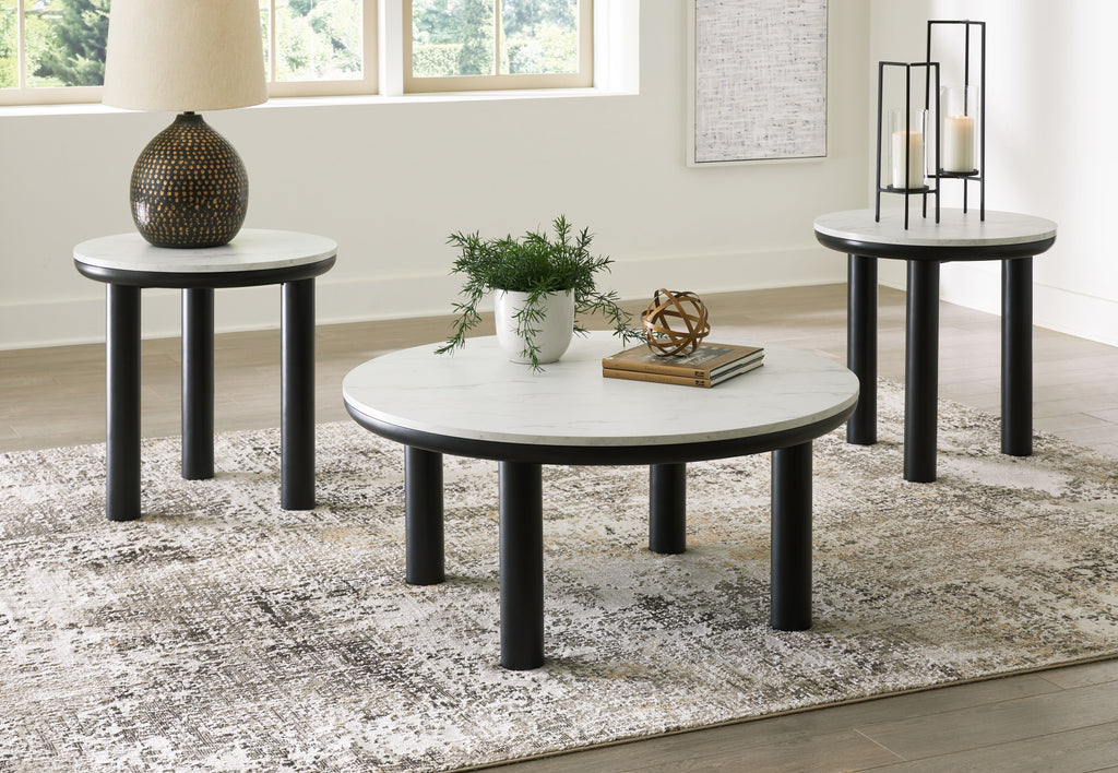 Set of 3 round side tables with white tabletops and black legs in a room