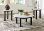 Set of 3 round side tables with white tabletops and black legs in a room