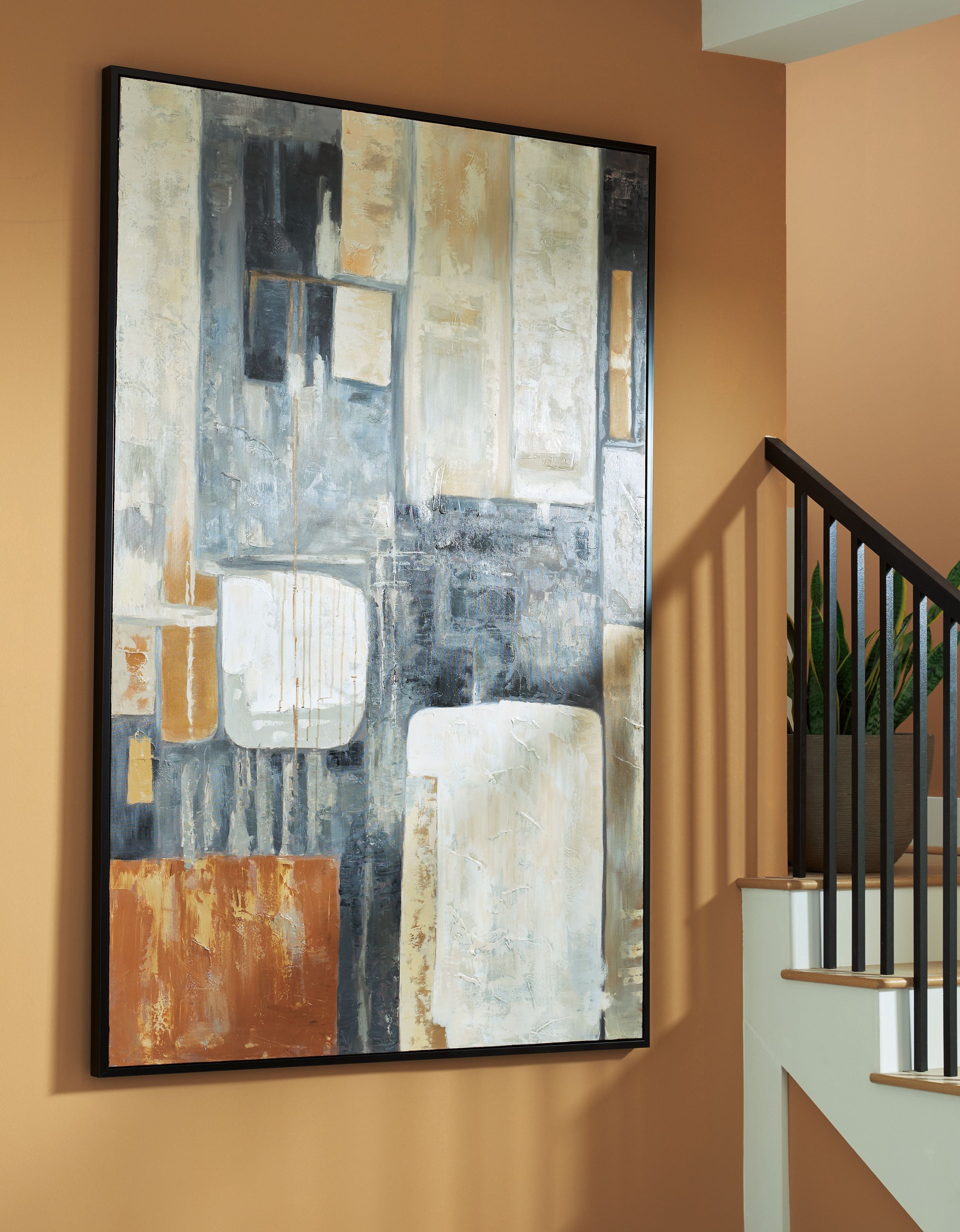Framed abstract wall art with geometric blocks in brown, black, gray, and cream