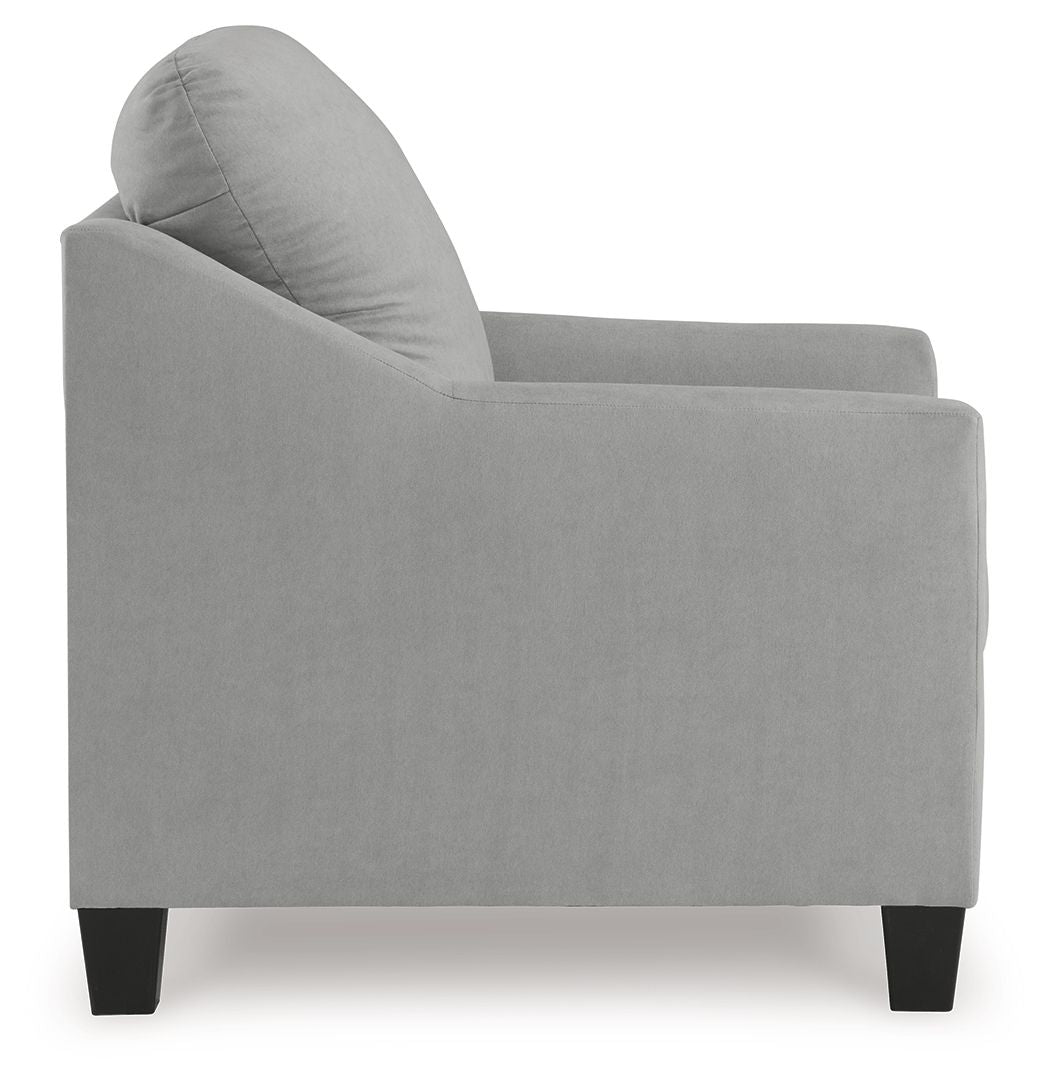Upholstered armchair in light gray with rounded seat and back, visible side profile.