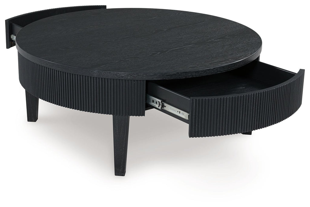 Black round cocktail table with lift-up top and visible storage compartment