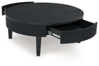 Black round cocktail table with lift-up top and visible storage compartment