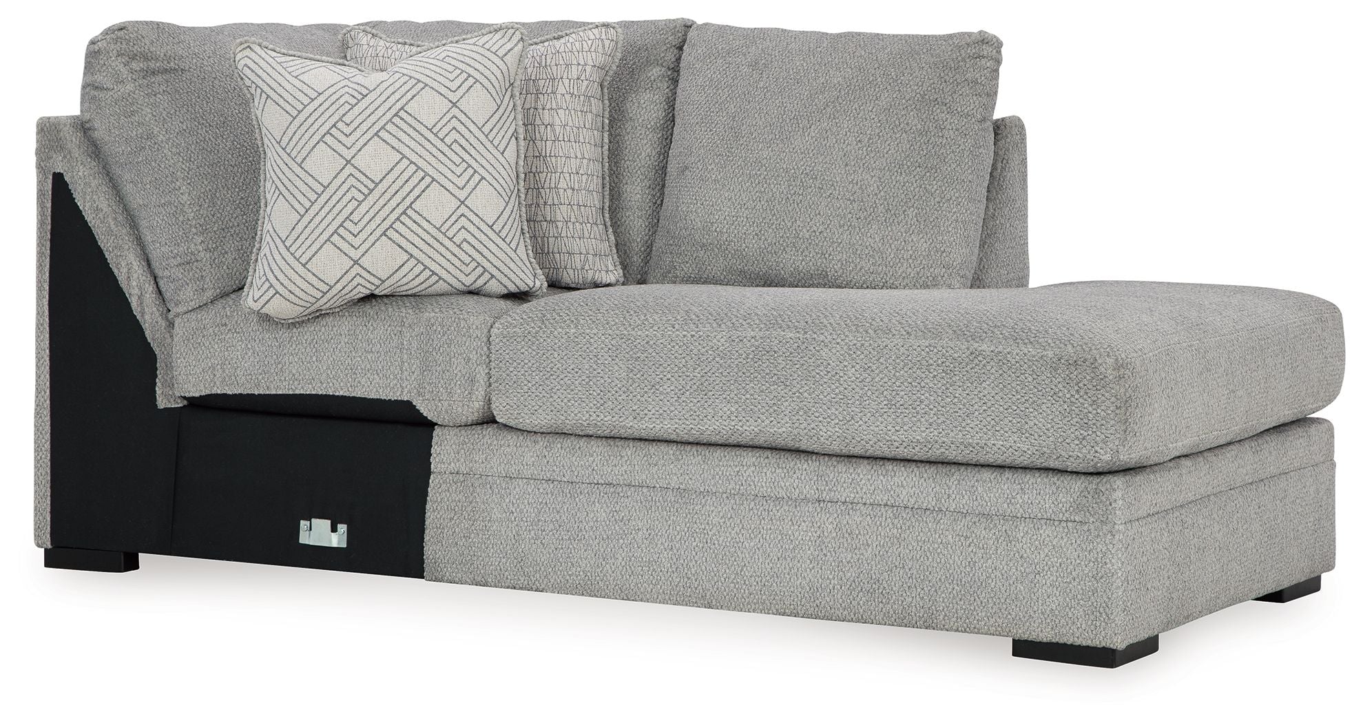 Cement gray corner chaise sofa with patterned throw pillows and black accent base