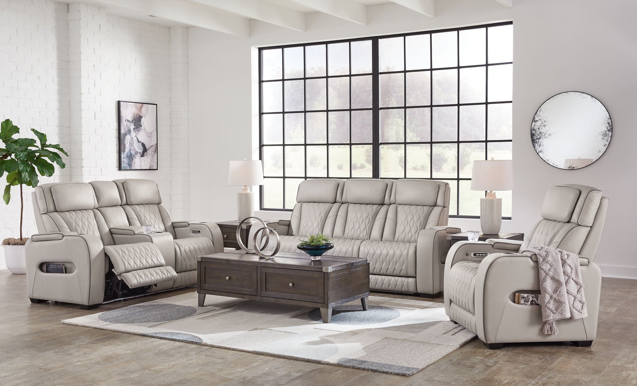 Gray reclining loveseat with two recliners, quilted upholstery, and padded headrests