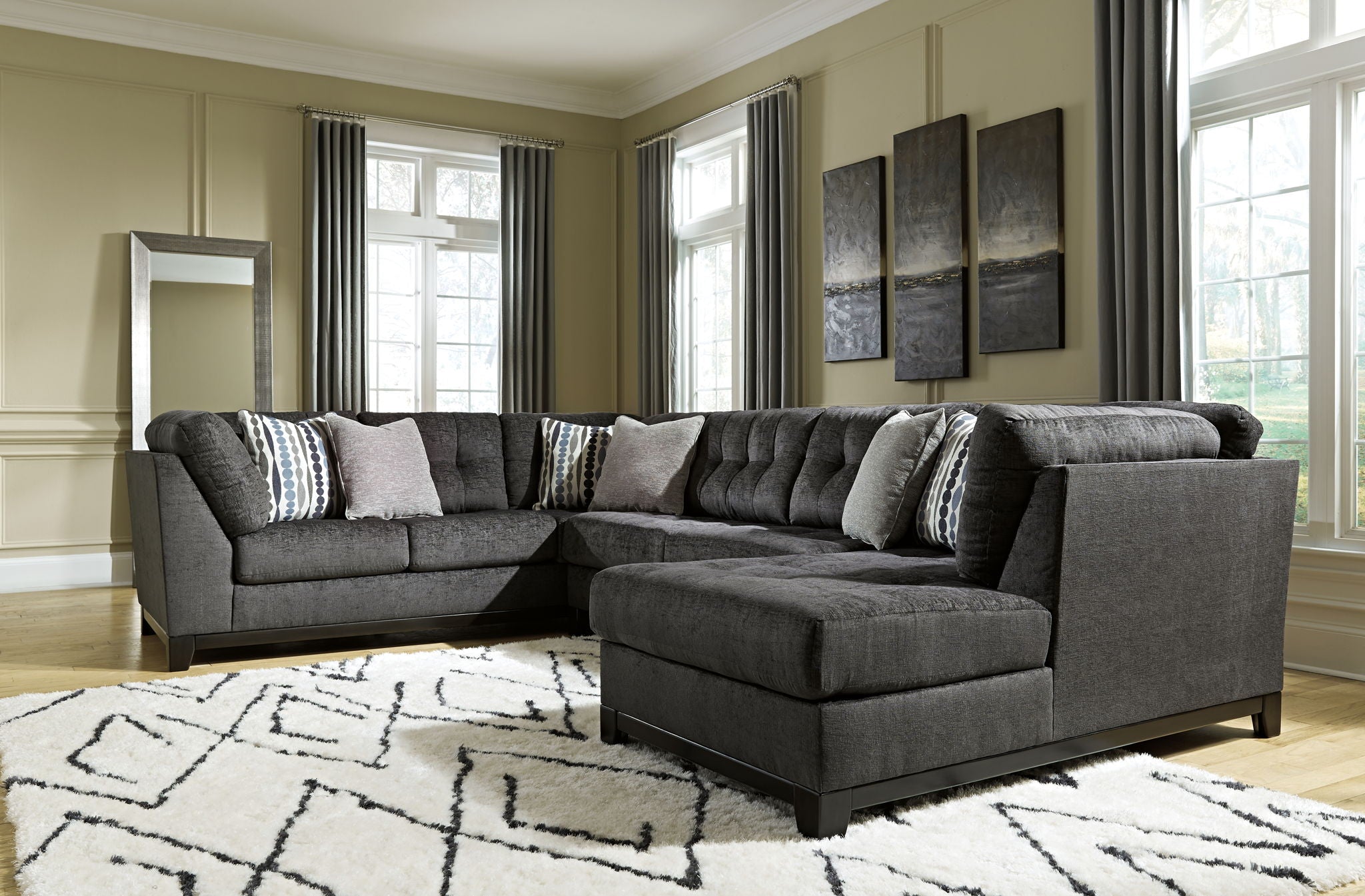 Gray sectional sofa with corner chaise and patterned throw pillows