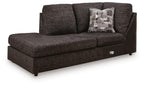 Dark charcoal corner chaise sofa with patterned throw pillow and armrests