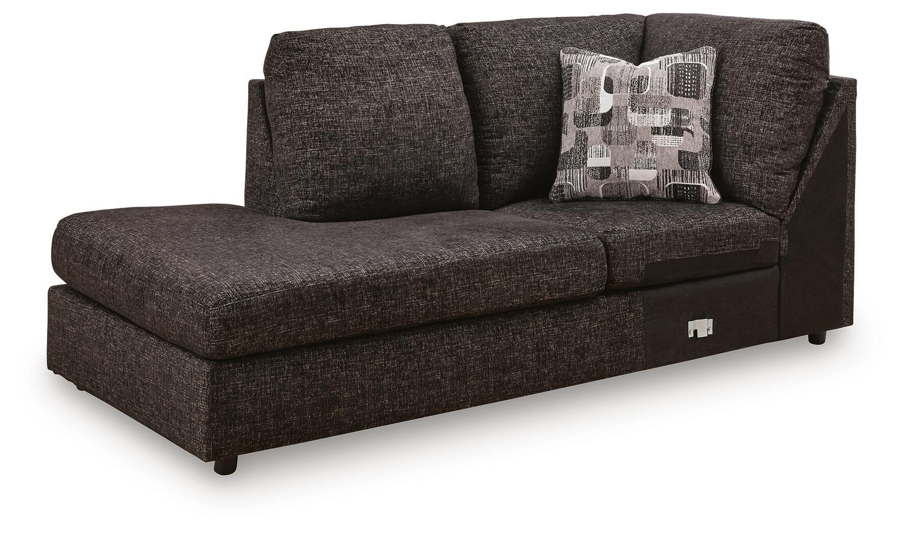 Dark charcoal corner chaise sofa with patterned throw pillow and armrests