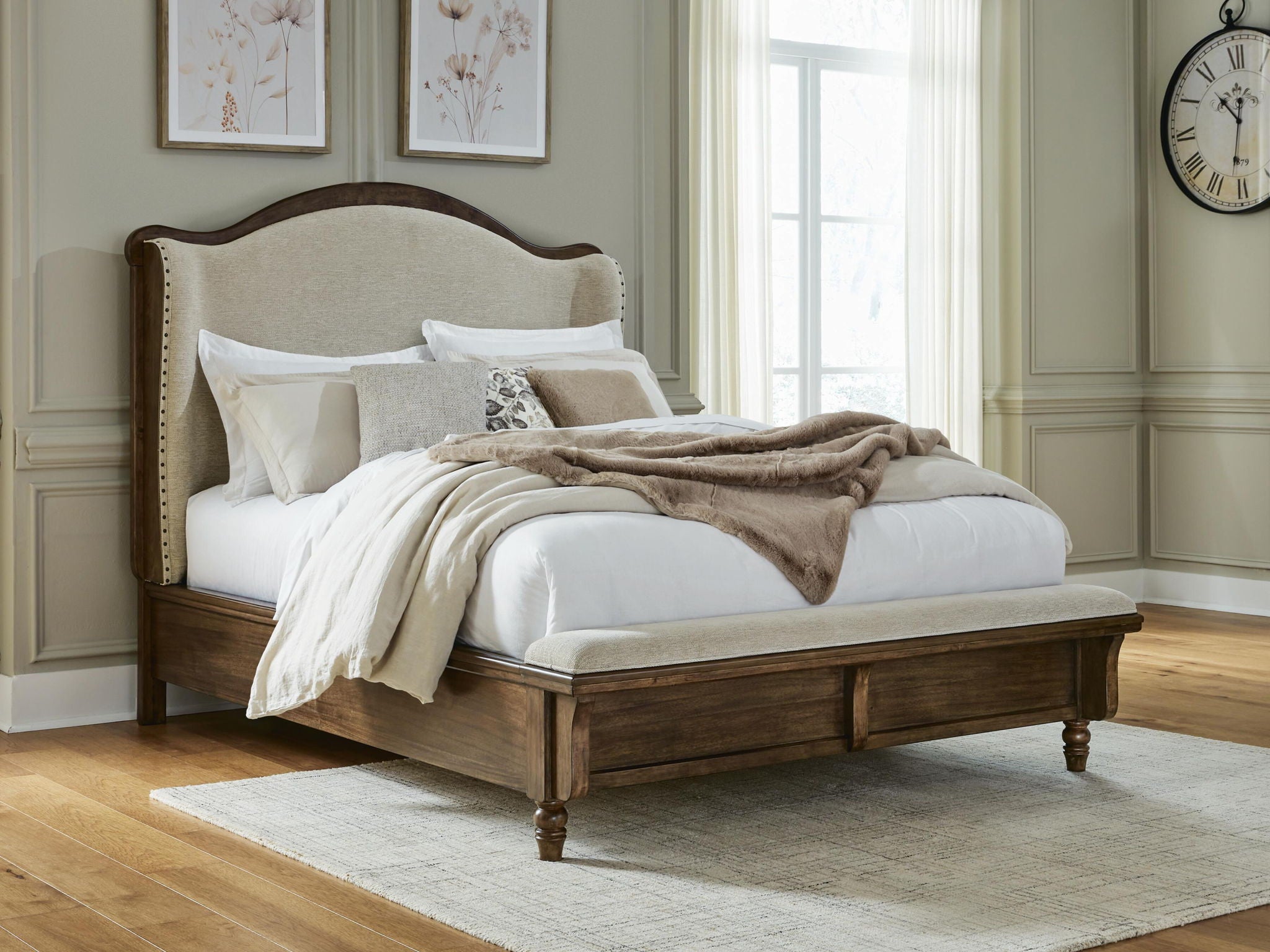 Upholstered panel bed with cream headboard and dark brown frame, styled with pillows
