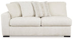Light ivory fabric sofa with two seat cushions and multiple back pillows