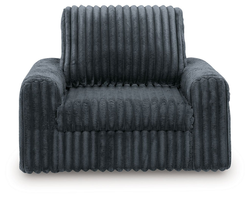Gunmetal corduroy power gliding chaise with tufted seat, rounded armrests, tall back.