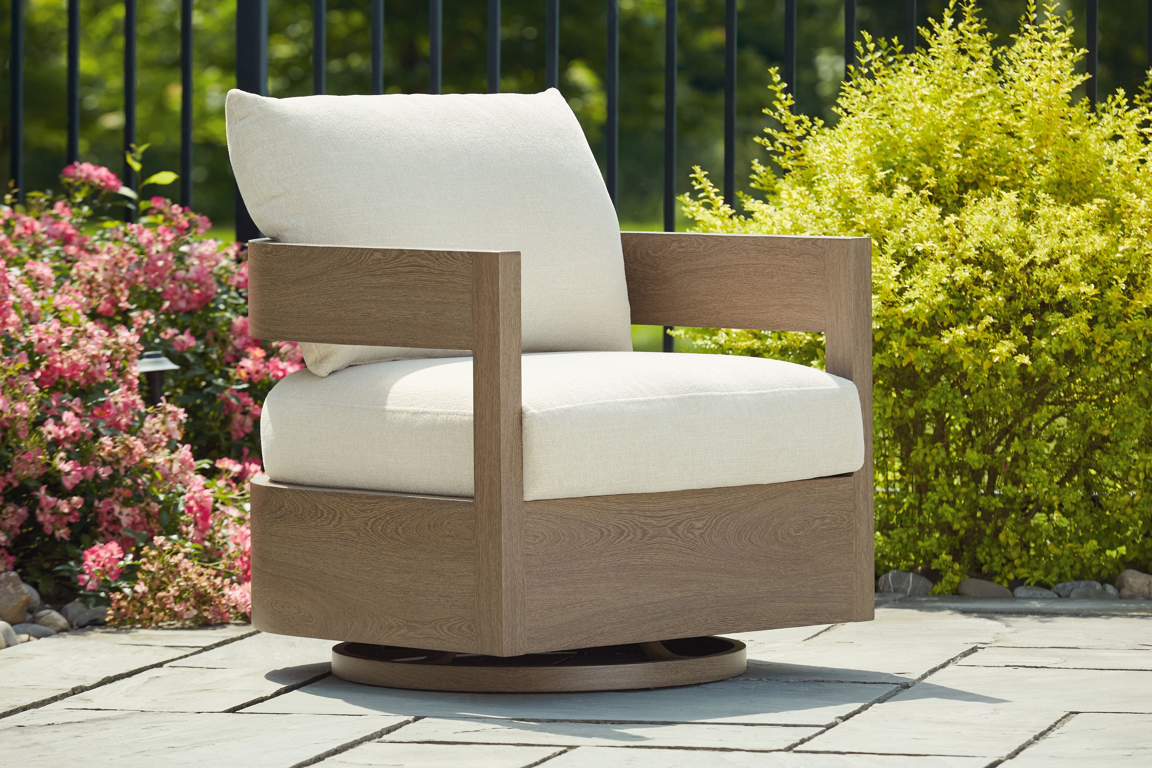 Swivel glider chair with white seat cushion and dark brown armrests