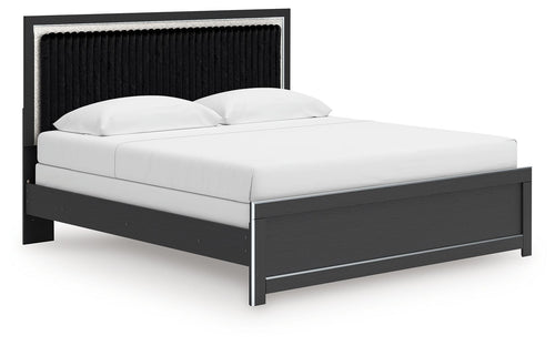 Upholstered panel bed with white bedding, black upholstered headboard, and dark platform rails