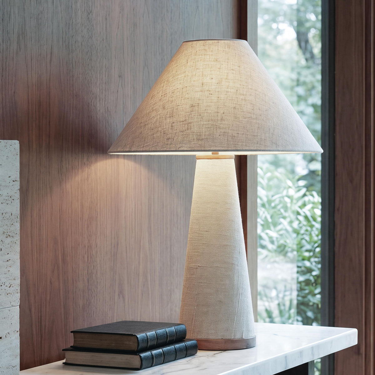 Beige fabric-shade metal lamp on a tabletop with wood accent base