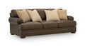 Carriage Point sofa in dark brown with three beige throw pillows