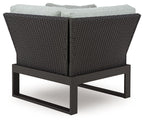 Black outdoor corner chair with gray seat cushion and woven back
