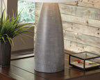 Table lamp shown from the side with white shade and dark gray textured base