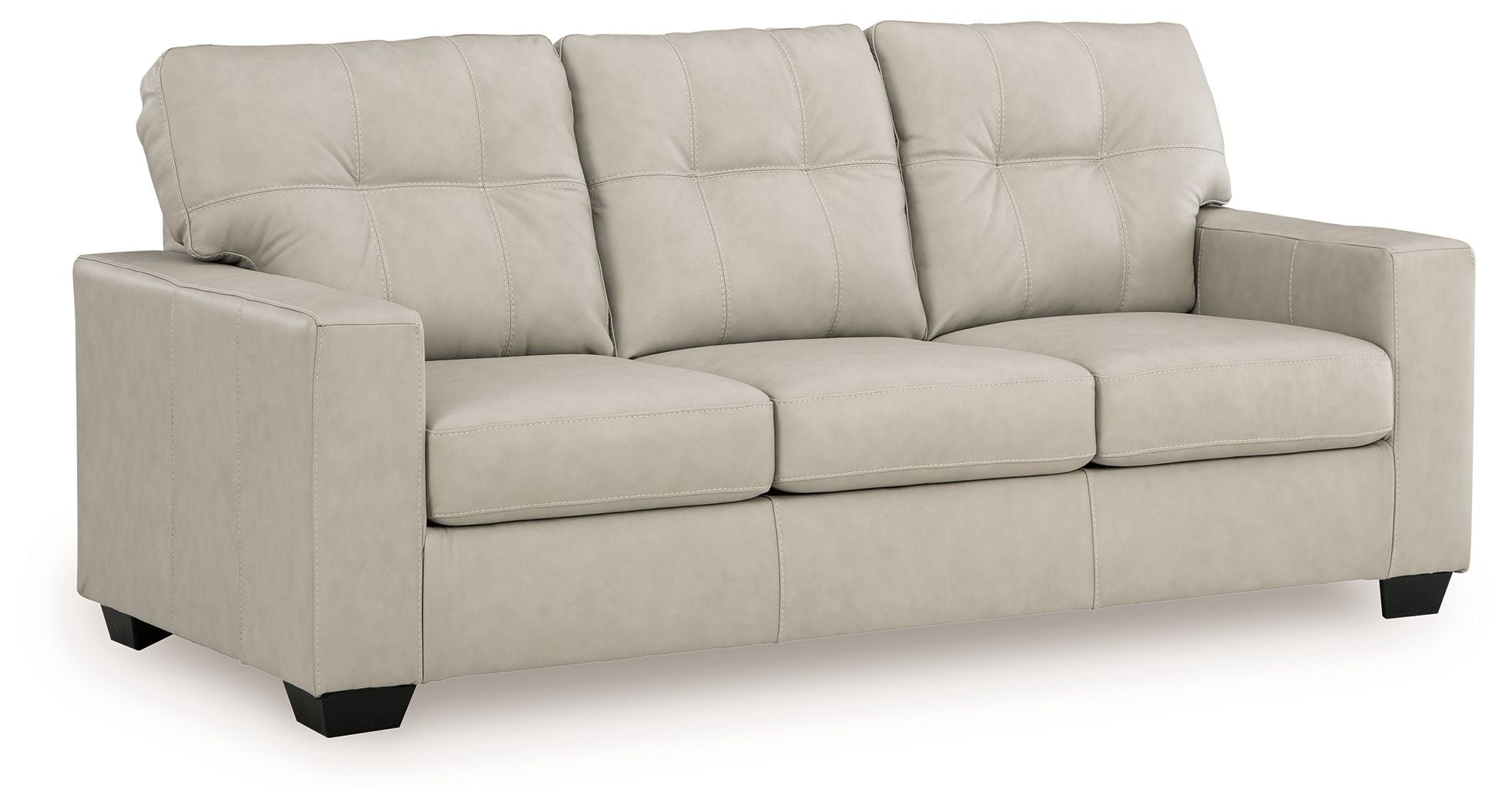 Beige fabric sofa with tufted back cushions and three padded seat sections
