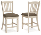 Pair of beige barstools with slatted backs and padded, dark fabric seats