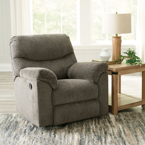 Alphons rocker recliner in putty fabric with cushioned arms and recline back, front angle