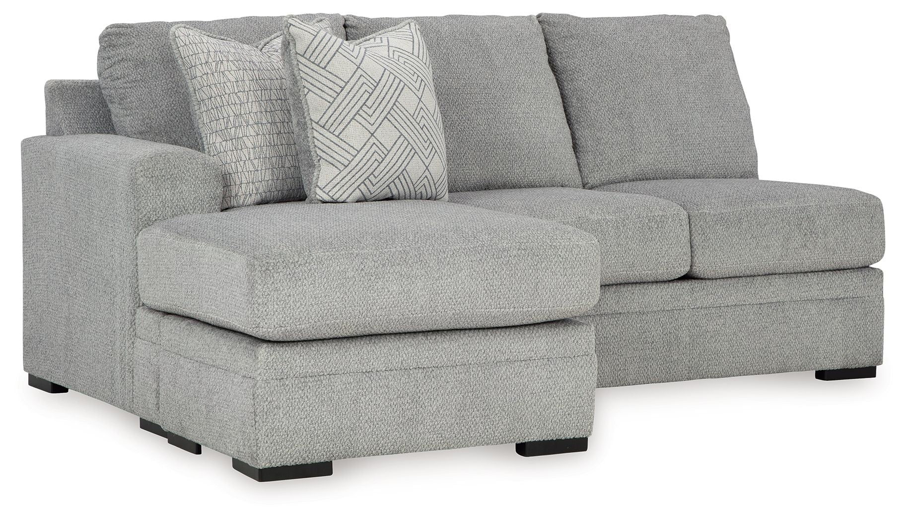 Gray sofa chaise with wide chaise seat, three back cushions, and patterned accent pillow