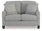 Gray upholstered loveseat with two front seat cushions and two striped back pillows