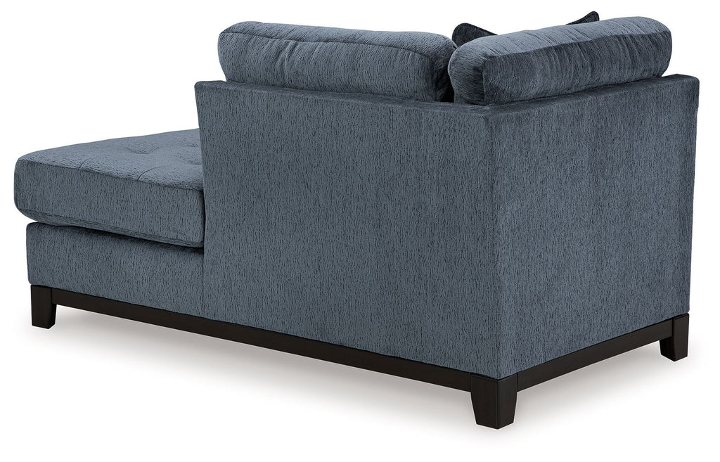 Navy fabric corner chaise with tufted arms and dark wood legs