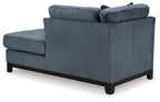 Navy fabric corner chaise with tufted arms and dark wood legs