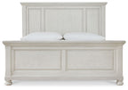 White panel bed frame close-up, paneled headboard and footboard with two pillows