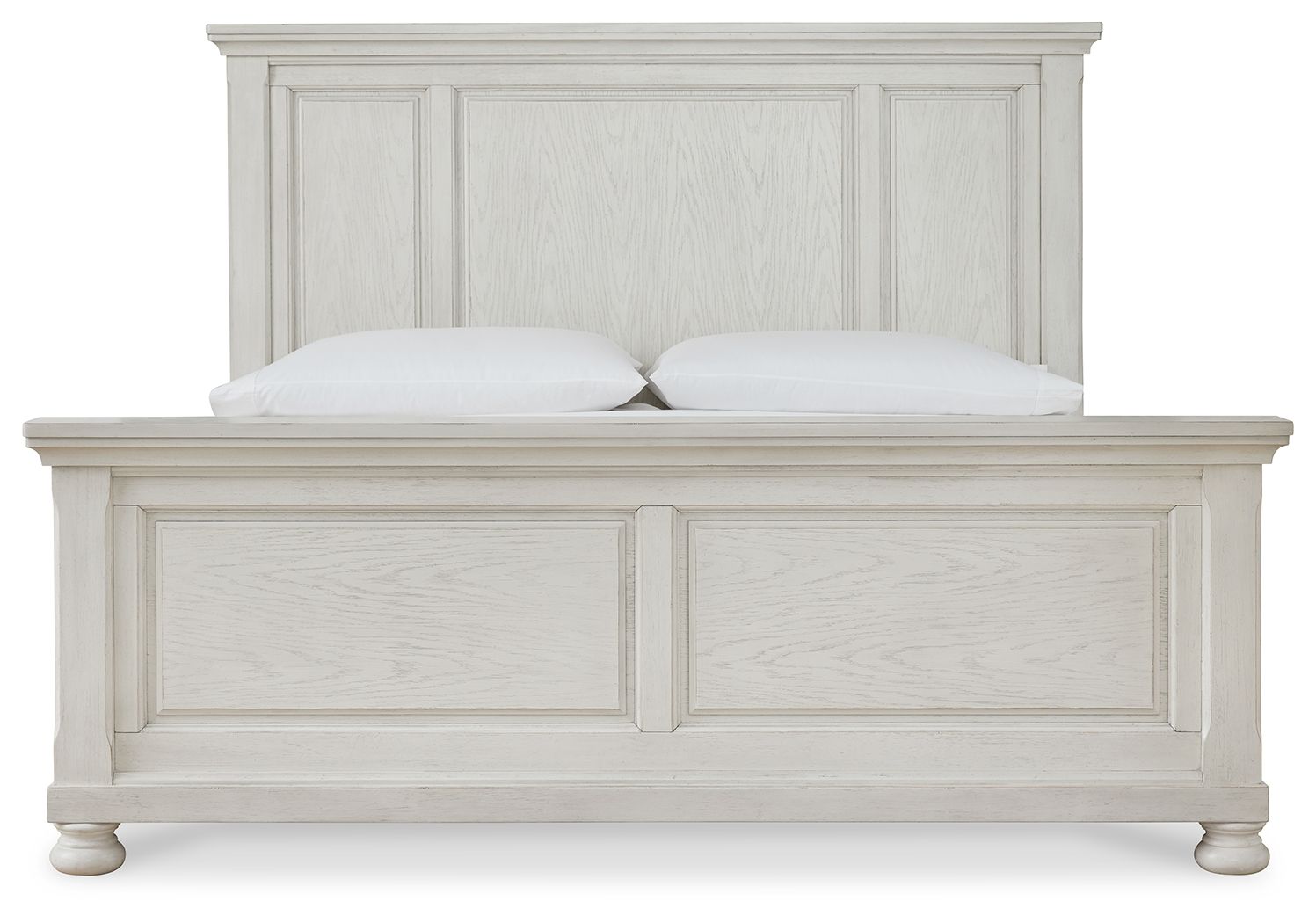 White panel bed frame close-up, paneled headboard and footboard with two pillows