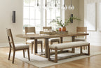 Light brown dining table with upholstered dining chairs