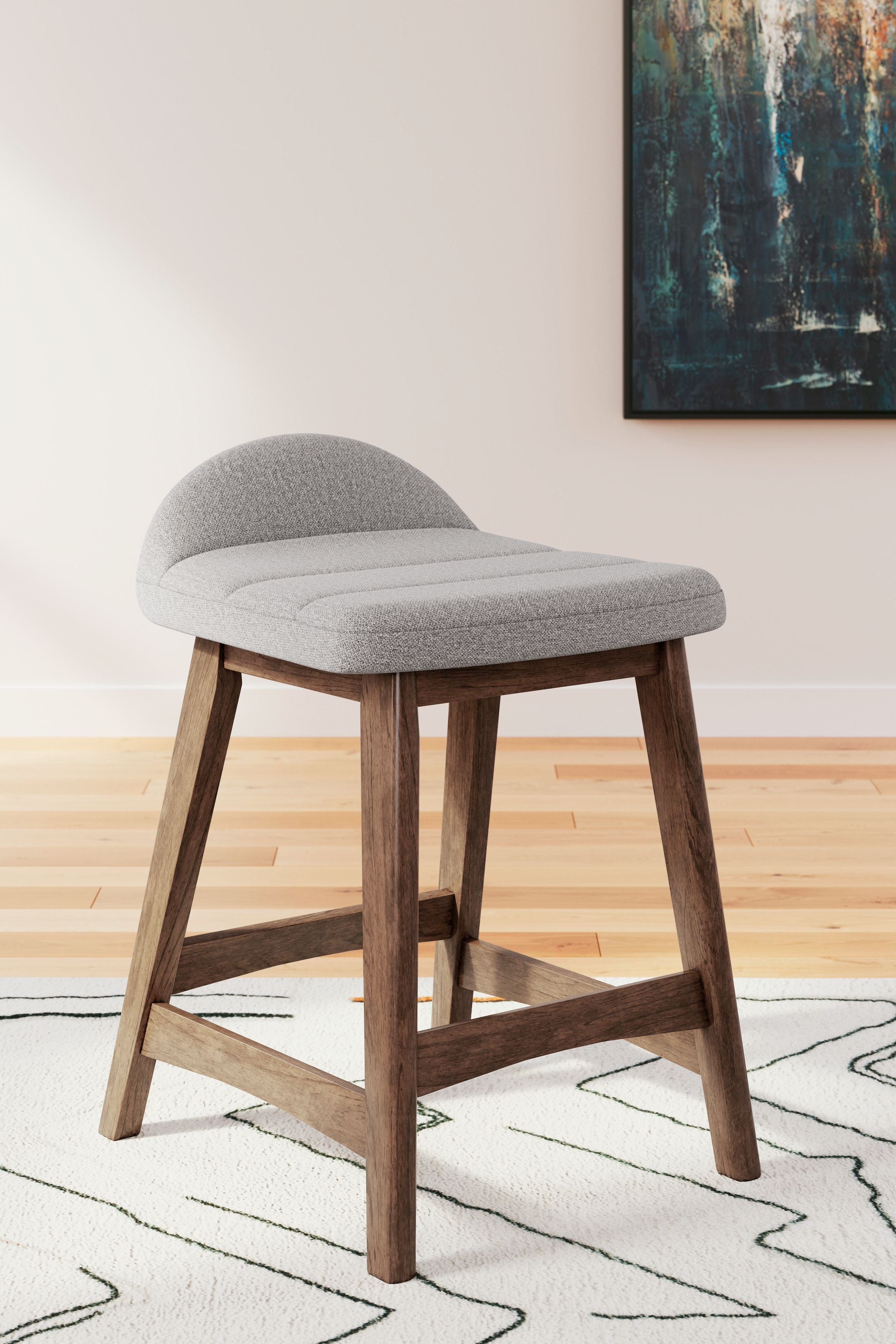 Upholstered barstool with light gray fabric seat and curved back, wood legs.