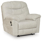 Light beige upholstered zero-wall recliner with tufted cushions, rounded armrests, and base
