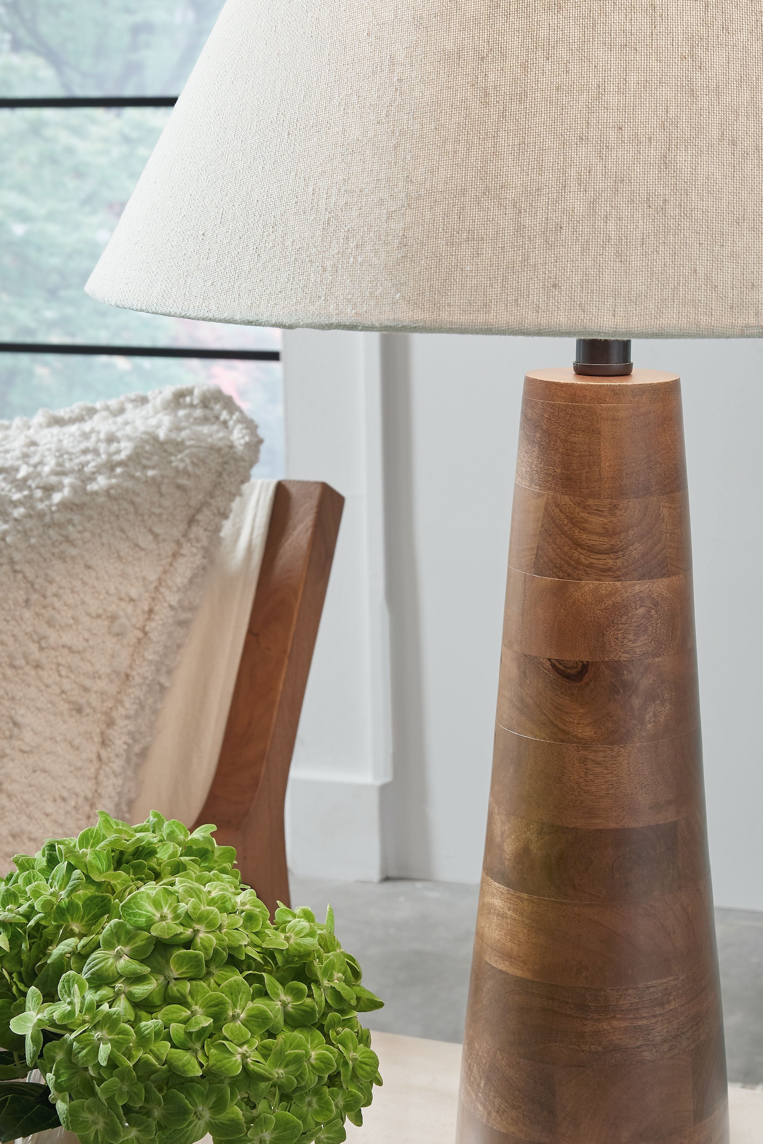 Floor lamp with off-white fabric shade and honey-brown tapered wood base