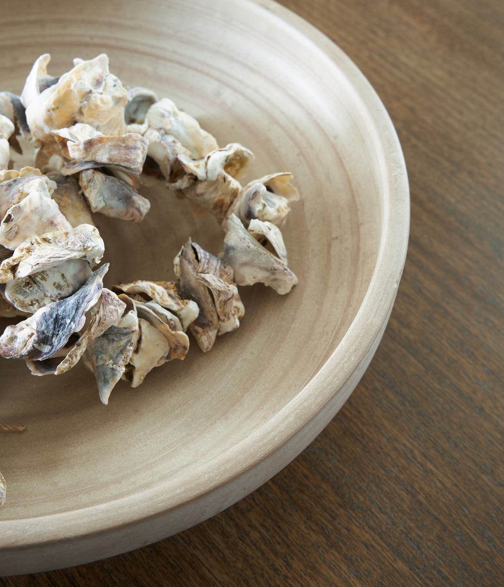 Antique beige ceramic bowl interior with decorative dried flowers resting inside