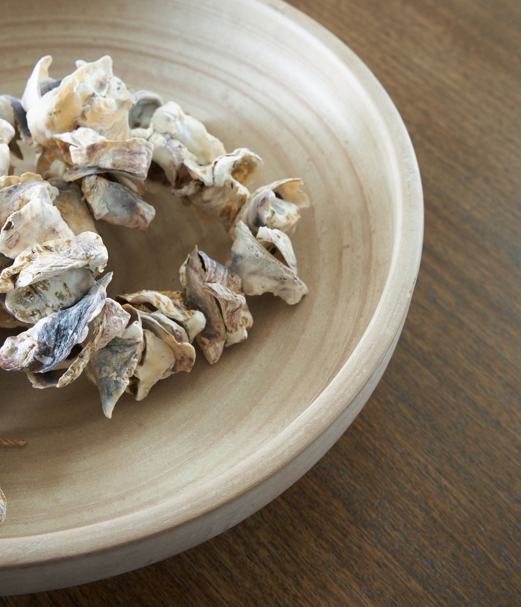 Antique beige ceramic bowl interior with decorative dried flowers resting inside
