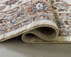 Beritham rug corner with textured pile and decorative pattern, cream edge binding visible