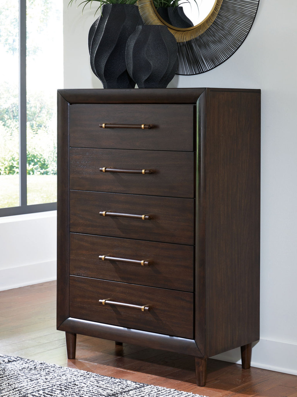 Five-drawer chest with brass bar pulls and dark wood finish, shown at an angle