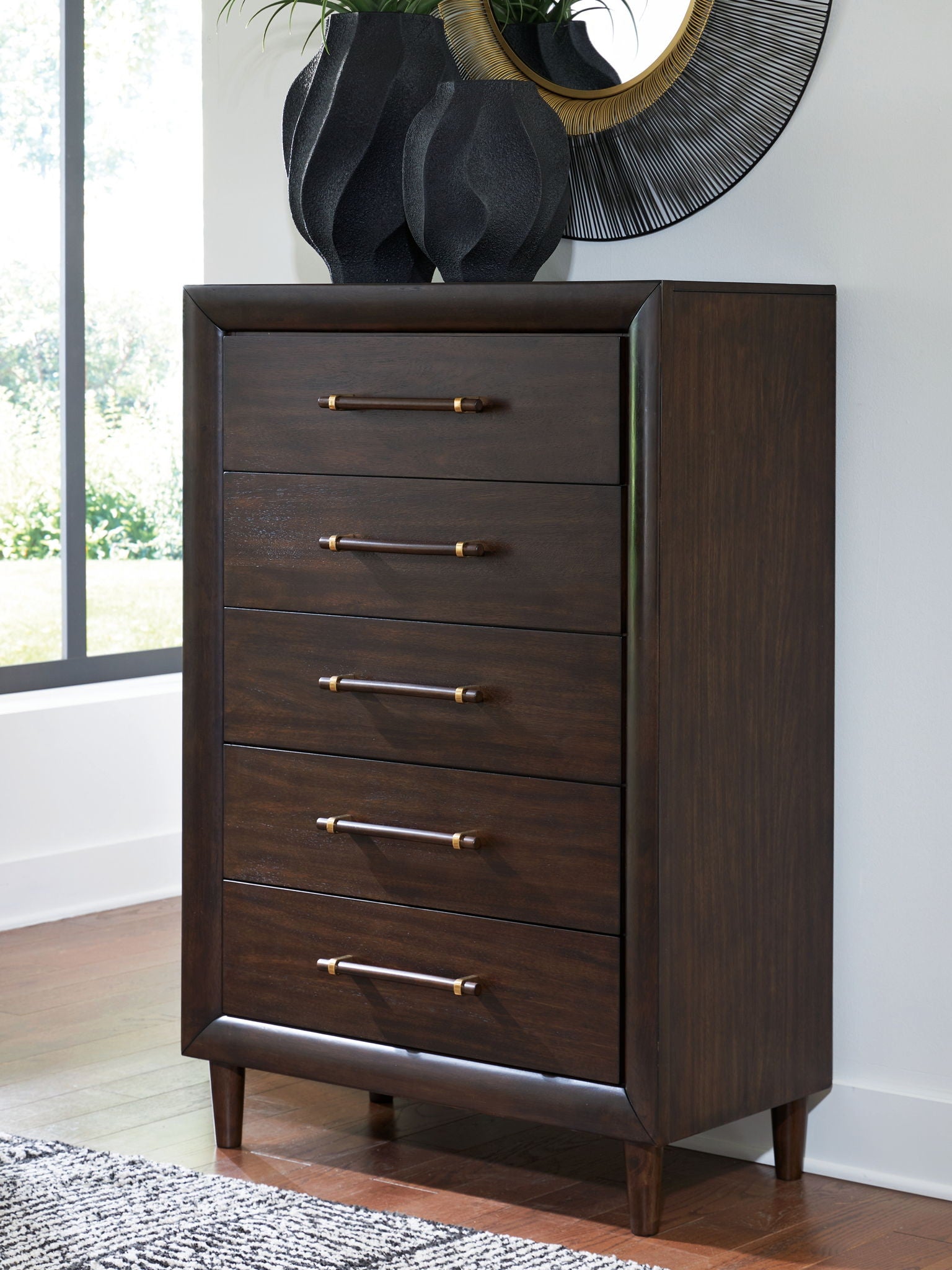 Five-drawer chest with brass bar pulls and dark wood finish, shown at an angle